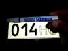 Is it legal to touch up car license plates with a marker?